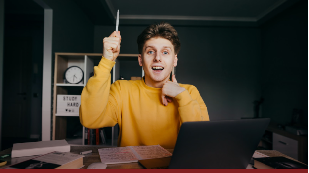 Man wearing a yellow footer holding his hand up